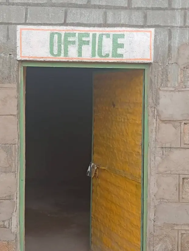 The painted office doorway of the hospital building